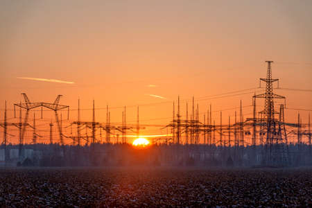 Electric substation with power lines at sunsetの写真素材