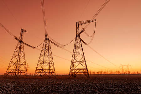 Big power lines against beautiful sunset skyの写真素材