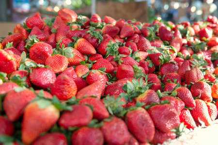 Big pile of fresh juicy strawberries in a marketの写真素材