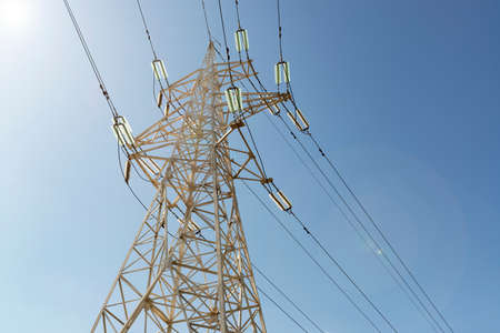 Pylon and wires of an electric powerline against blue skyの写真素材