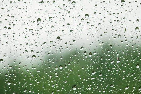 Rain drops on the window background. Rainy day background. Rainy weather forecastの写真素材
