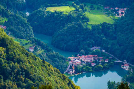 Magic river valley from above. Beautiful Soca valley in Slovenia with picturesque Most na Soci town. Popular travel destination in Europe.の写真素材
