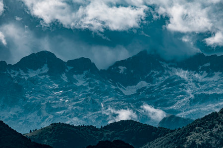 Stormy clouds over alpine peaks. Dramatic photo of Julian Alps in Soca valley, Slovenia.の写真素材