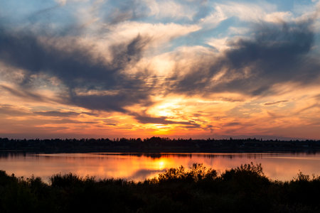 Amazing sunset colored sky with reflection in the lakeの写真素材
