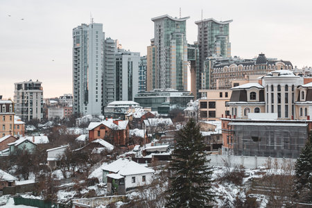 Winter Kyiv panorama. View on Kyiv city in Ukraine with modern high rise buildings and old private housesの写真素材