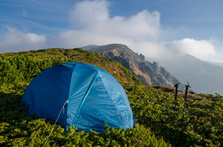 Hiking tent on the mountain top. Bivouac with a view high in the mountains.の写真素材