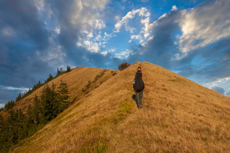 Hikers with backpacks climbing on the hill. Active lifestyle and outdoor sportの写真素材