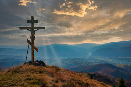 Christian cross on the mountain top at the sunset. Symbol of Christianity and Saviourの写真素材