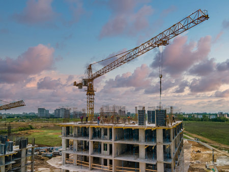 2021-05-21 Kyiv, Ukraine. Workers on the top of the building with cranes. Day at the construction site. Rebuilding Ukraineのeditorial素材