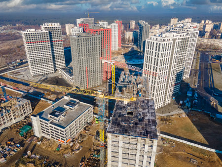 Big construction site with cranes from above. New real estates construction. Construction site in a sunny dayの写真素材