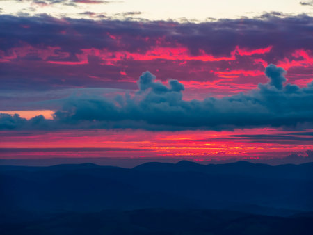 Burning sunset sky. Dramatic vibrant sunset in the mountains. Nature backgroundの写真素材