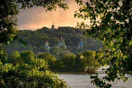Kyiv city view at the sunset. Beautiful monastery on the left bank of Dnipro river in Kyivの写真素材