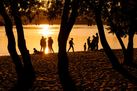 Kyiv, Ukraine, May 2023, people chilling on a beach at sunsetのeditorial素材