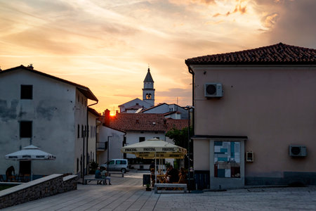 Vipavski KriÅ¾, Slovenia, August 2021. Evening in the medieval town, people sitting in a street cafe under beautiful sunset sky.のeditorial素材