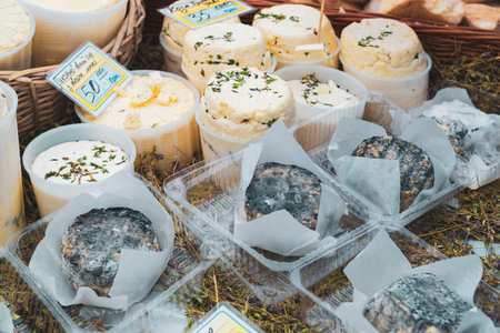 Variety of craft cheese on the farm fair. Sale of the homemade cheeseの写真素材