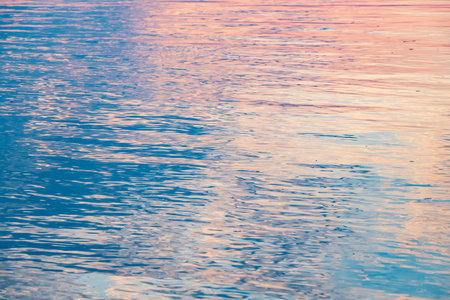 Ripple in still water on the sunset backgroundの写真素材