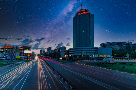 2013-06-05 Kyiv, Ukraine. Night traffic in the city with car light trails and starry sky above. Sky is artificially addedのeditorial素材
