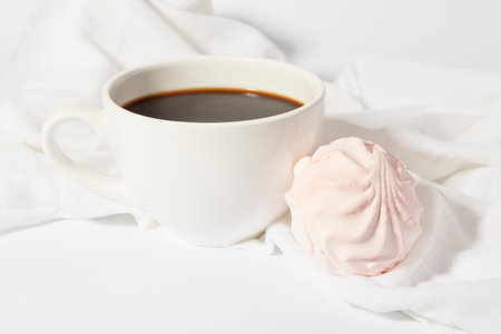 Delicious morning coffee on white with marshmallowの写真素材
