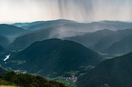 Rain shower in the mountains. Unexpected weather change.の写真素材