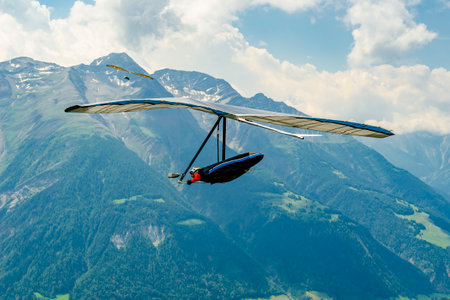 Hang gliders in the Swiss Alps. Modern free flight wings go airborne in Fiesch, Switzerlandの写真素材