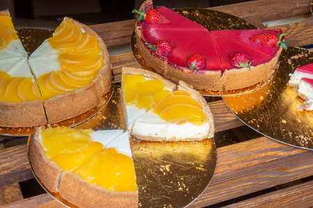 Set of various heesecakes sliced on the foil plates