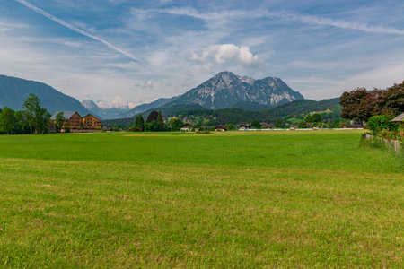 Picturesque green alpine meadow surrounded by mountain peaks. Green alpine pasture. Loser and Altaussee lake with Dachstein plateau on the background. Austrian landscapeの写真素材