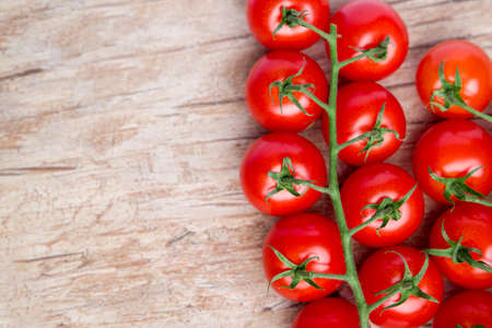 Cherry tomatoes on a wooden background.の写真素材
