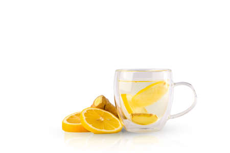 Medicinal tea with lemon and ginger. Slices of lemon, ginger and a clear glass mug with tea.の写真素材