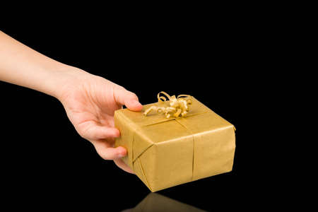 hand holding gift box isolated on black backgroundの写真素材