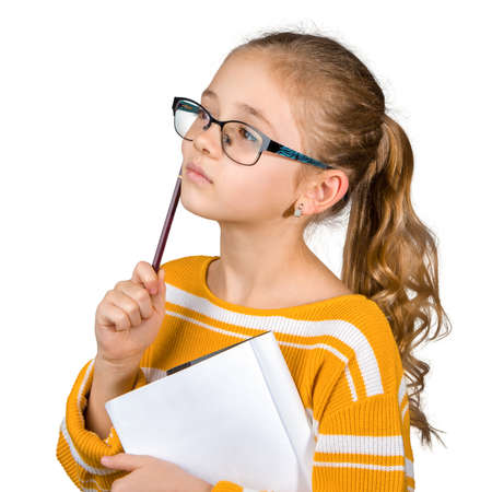 The girl in glasses with a pen and a notebook thinks. The concept. Isolated on white.の写真素材