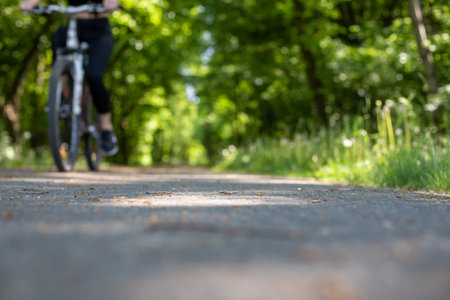 person riding a bicycle, selective focus, soft focus