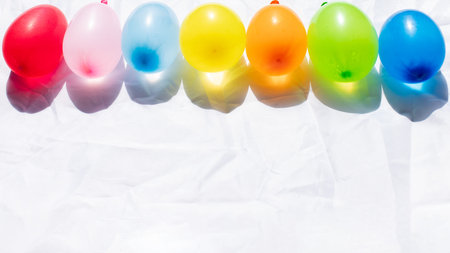 A line of colorful balloons on a white background,