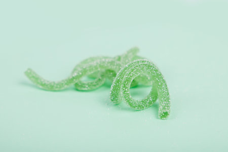 Green jelly candies on a mint background.の写真素材