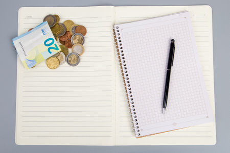Notebook with money and pen on gray background. business concept.の写真素材