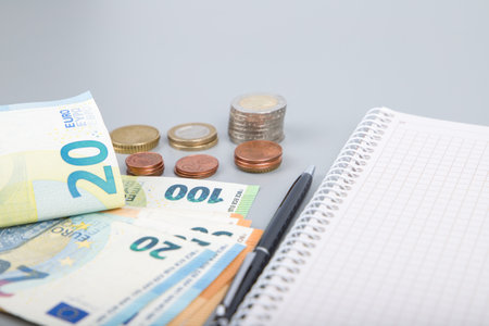 financial accounting background with euro coins and money, close upの写真素材