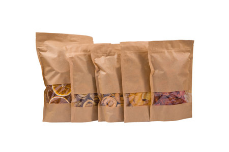 Brown paper bag with dried fruits isolated on white background.の写真素材
