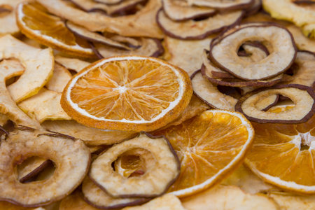Dried fruit chips, dried orange and apple slices, close upの写真素材
