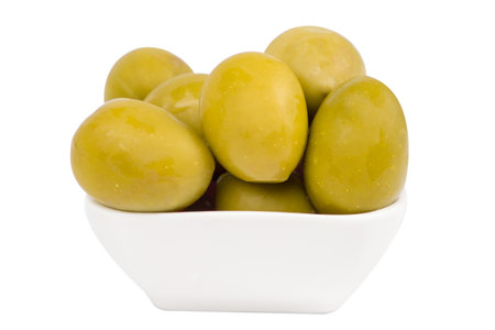 Green olives in a bowl on a white background. Isolatedの写真素材