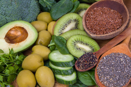 Healthy food ingredients: spinach, avocado, cucumber, olives, flax seedsの写真素材