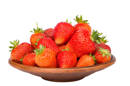 strawberries in a clay bowl isolated on a white background.の写真素材