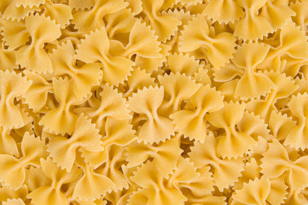 close up of a uncooked italian farfalle pasta backgroundの写真素材