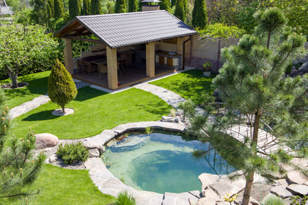 Garden house and pond in the backyard. View from above.