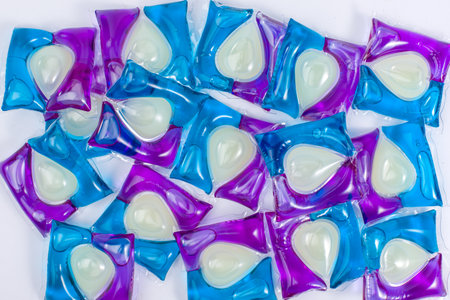 Background of capsules with washing gel in blue, purple and white colors. Top view.の写真素材