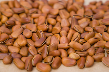 Pine nuts on a wooden background. Close-up shot. Selective focus.