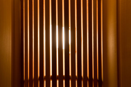 Lamplight through the blinds. Abstract background.