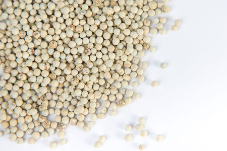 white pepper seeds on white background. Close up. Top view.の写真素材