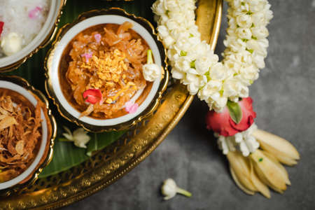 A Cooling Thai Summer TreatThai Khao Chae With mellow side dishes such as bell peppers stuffed with pork and shrimp Egg wrapped in tiger hand, shredded pork, stir-fried radish Dried chili stuffed with shallot stuffed with fried shrimp paste balls and sweet stir-fried yison fishの写真素材