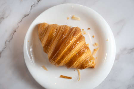 A croissant  is a buttery, flaky, viennoiserie pastry of Austrian origin. Croissants are named for crescent shape and are made of a layered yeast-leavened dough  called laminating.の写真素材