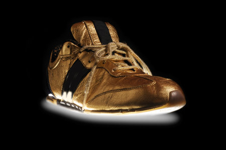 A pair of golden  sneakerの写真素材