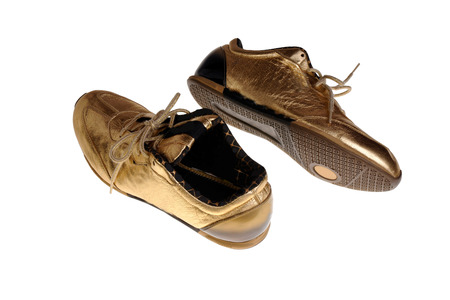 A pair of golden  sneakerの写真素材